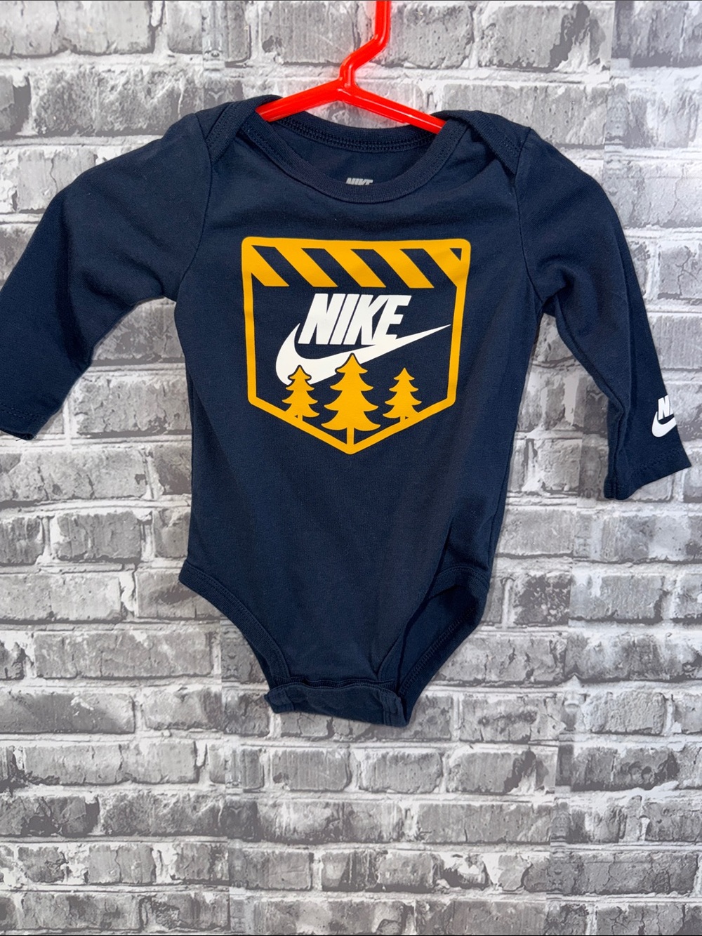 Nike Navy Long-Sleeve Baby One-Piece with Yellow Crest